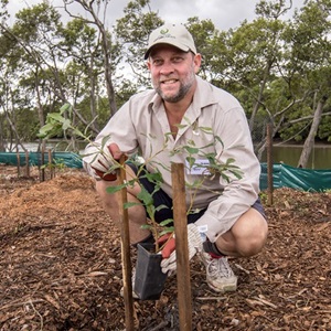 Cameron Jackson planting trees
